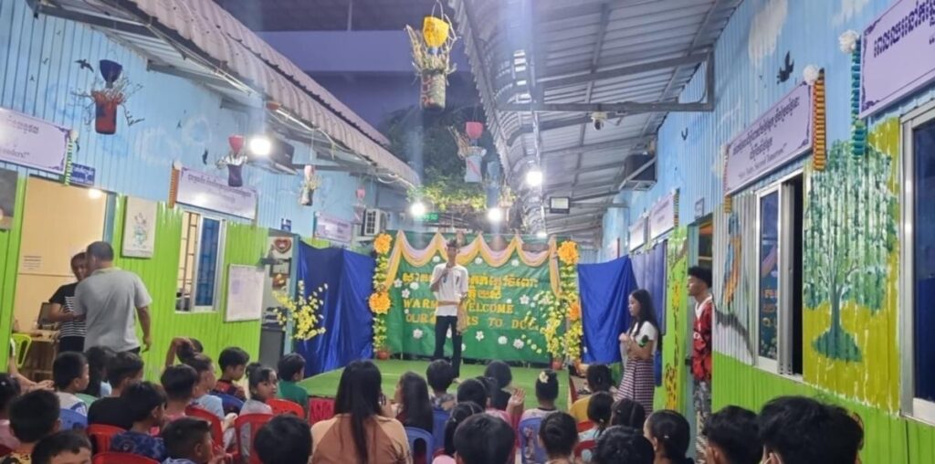 DCC students hosting a welcome event on stage for visitors