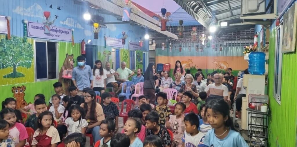 Students and visitors filling a decorated DCC classroom